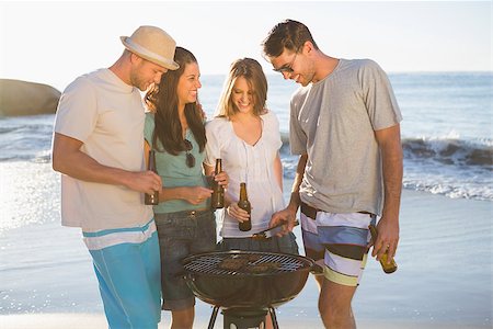 simsearch:6109-06781569,k - Cheerful young friends having barbecue together on the beach Stock Photo - Budget Royalty-Free & Subscription, Code: 400-06930600