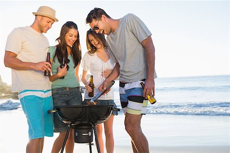 simsearch:6109-06781569,k - Smiling young friends having barbecue together on the beach Stock Photo - Budget Royalty-Free & Subscription, Code: 400-06930601
