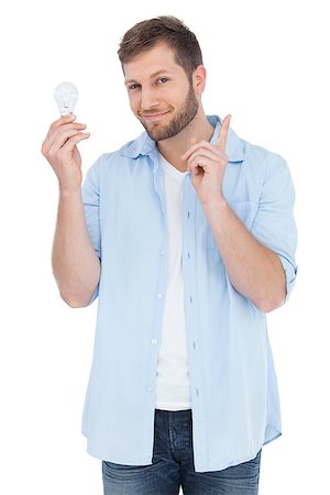 Charming model on white background holding a bulb in right hand on white background Stock Photo - Budget Royalty-Free & Subscription, Code: 400-06931739