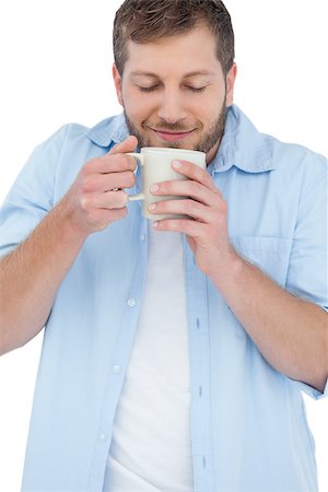 Casual model on white background having coffee and smelling it Photographie de stock - Aubaine LD & Abonnement, Code: 400-06931760