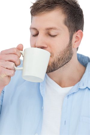 Casual model on white background drinking a coffee Photographie de stock - Aubaine LD & Abonnement, Code: 400-06931763