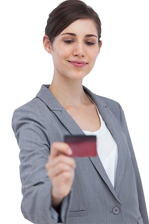 simsearch:400-06858518,k - Confident businesswoman on white background holding credit card Stock Photo - Budget Royalty-Free & Subscription, Code: 400-06931980
