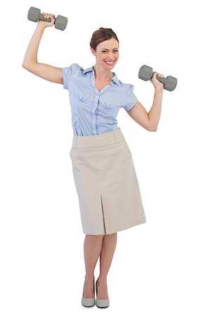 Strong businesswoman lifting dumbbells looking at camera against white background Stock Photo - Budget Royalty-Free & Subscription, Code: 400-06932080