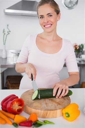 simsearch:6109-08390293,k - Smiling woman cooking at home Stock Photo - Budget Royalty-Free & Subscription, Code: 400-06932553