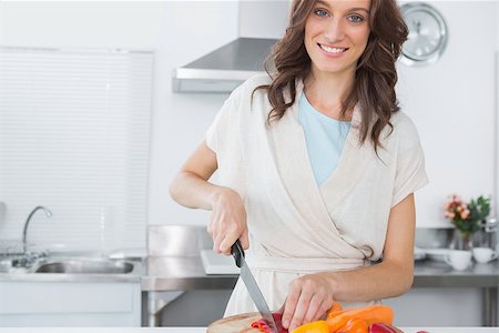 simsearch:6109-08390293,k - Pretty brunette posing while cooking in her kitchen Stock Photo - Budget Royalty-Free & Subscription, Code: 400-06932714