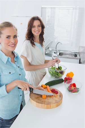 simsearch:6109-08390293,k - Women cooking together in the kitchen and looking at camera Stock Photo - Budget Royalty-Free & Subscription, Code: 400-06932723