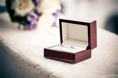 Wedding rings in a box with blurred bouquet on background Stock Photo - Budget Royalty-Free & Subscription, Code: 400-06947398