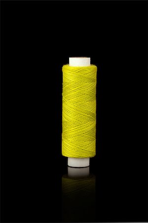 simsearch:6109-08701535,k - Yellow spindle of yarn isolated over black background Stock Photo - Budget Royalty-Free & Subscription, Code: 400-06947588