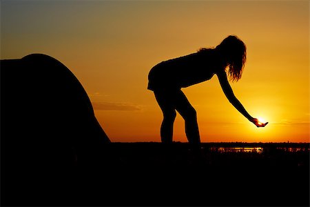 Silhouette of a woman having fun near a camping tent at sunset. Stock Photo - Budget Royalty-Free & Subscription, Code: 400-06947875