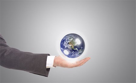 simsearch:400-06089187,k - business man with earth globe in his hand, grey background Stock Photo - Budget Royalty-Free & Subscription, Code: 400-06949417