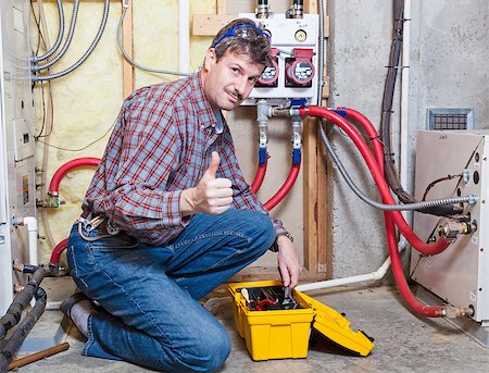 pipe wrench - Happy handyman showing thumbs up Stock Photo - Budget Royalty-Free & Subscription, Code: 400-06954159