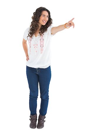 simsearch:400-04856416,k - Cheerful attractive brunette wearing casual clothes pointing on white background Stock Photo - Budget Royalty-Free & Subscription, Code: 400-06954755