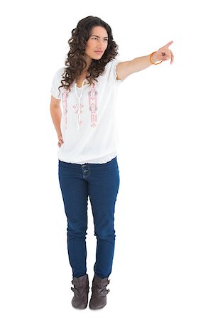 simsearch:400-04856416,k - Serious attractive brunette wearing casual clothes pointing on white background Stock Photo - Budget Royalty-Free & Subscription, Code: 400-06954756