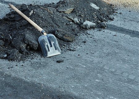 stone dust - Shovel for construction works on a heap of old asphalt Stock Photo - Budget Royalty-Free & Subscription, Code: 400-06950842