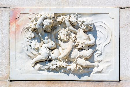 simsearch:400-05338054,k - Ornamental allegoric bas-relief marble sculpture with babies on Peles castle wall in Sinaia, Romania. Stock Photo - Budget Royalty-Free & Subscription, Code: 400-06952378