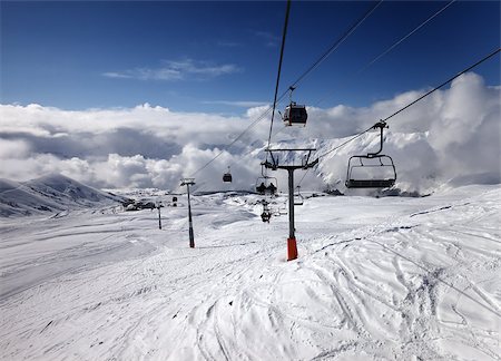 simsearch:400-04636750,k - Gondola and chair lift at ski resort. Caucasus Mountains. Georgia, Gudauri. Stock Photo - Budget Royalty-Free & Subscription, Code: 400-06953140