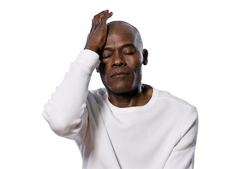 Close-up of a serious afro American man with headache in studio on white isolated background Stock Photo - Budget Royalty-Free & Subscription, Code: 400-06953334