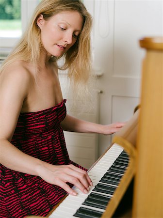 pianist (female) - Photo of a happy blond female in her early thirties playing the piano at home. Stock Photo - Budget Royalty-Free & Subscription, Code: 400-06953716