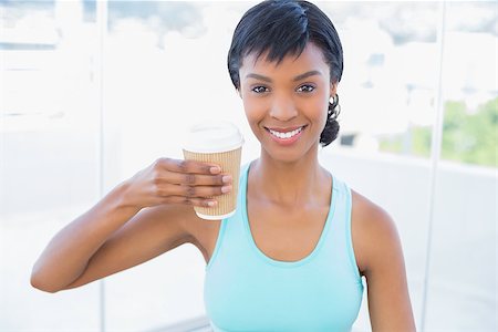 Pleased black haired woman holding a beverage in a living room Stock Photo - Budget Royalty-Free & Subscription, Code: 400-06960730