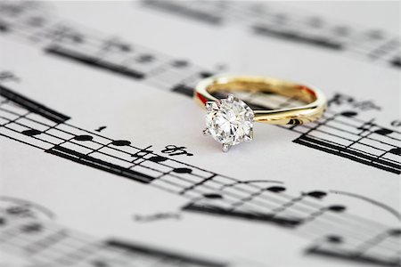 simsearch:400-04570412,k - Ideal cut solitaire diamond on yellow gold onto music score. Stock Photo - Budget Royalty-Free & Subscription, Code: 400-07035977