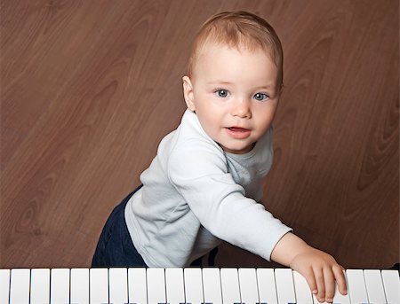 picture of the blue playing a instruments - portrait of little baby child  play music on black and white piano keyboard Stock Photo - Budget Royalty-Free & Subscription, Code: 400-07036246