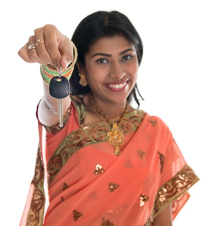 Attractive traditional Indian woman in sari holding her first own car key isolated on white background. Focus on car key. Foto de stock - Super Valor sin royalties y Suscripción, Código: 400-07045573