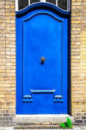 simsearch:400-07257534,k - Closed blue entrance door in brick wall Stock Photo - Budget Royalty-Free & Subscription, Code: 400-07045894