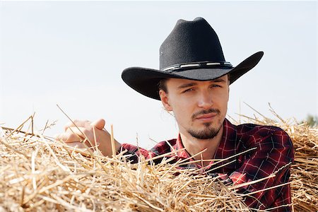 young cowboy leaning on haystack Stock Photo - Budget Royalty-Free & Subscription, Code: 400-07048848