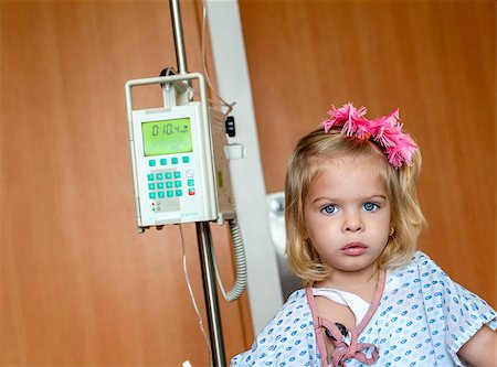 Recovering Little baby girl hospitalized with a Intravenous bag on a pole. Real situation Stock Photo - Budget Royalty-Free & Subscription, Code: 400-07048883