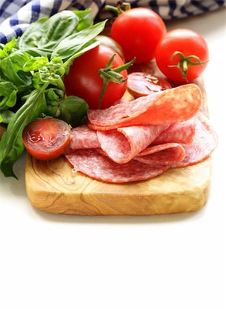 simsearch:400-06207145,k - smoked sausage, tomatoes and basil on a wooden cutting board Stock Photo - Budget Royalty-Free & Subscription, Code: 400-07055678