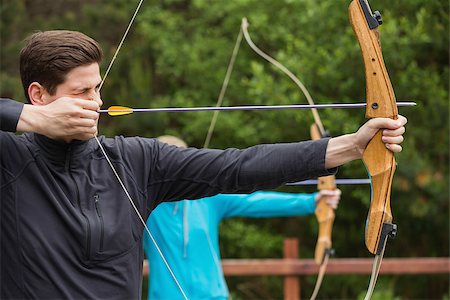 Handsome man practicing archery at the archery range Stock Photo - Budget Royalty-Free & Subscription, Code: 400-07058545