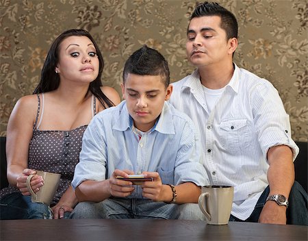 simsearch:400-05918419,k - Nosey parents behind teenage son sending text messages Stock Photo - Budget Royalty-Free & Subscription, Code: 400-07050206