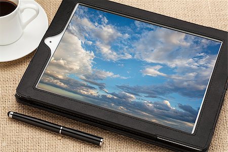 cloud computing concept - a stormy cloudscape on digital tablet computer together with a cup of coffee and stylus pen Photographie de stock - Aubaine LD & Abonnement, Code: 400-07053572
