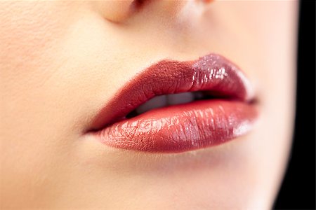 simsearch:400-05027723,k - Close up on beautiful models glossy lips on black background Stock Photo - Budget Royalty-Free & Subscription, Code: 400-07060188