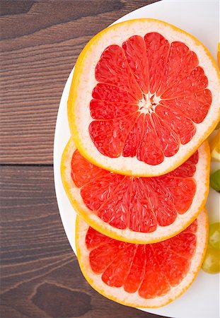 simsearch:400-06513460,k - Slice of red fresh grapefruit on a palte Stock Photo - Budget Royalty-Free & Subscription, Code: 400-07061594