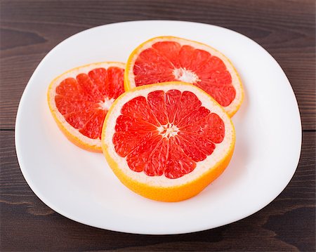 simsearch:400-06513460,k - Slice of red fresh grapefruit on a palte Stock Photo - Budget Royalty-Free & Subscription, Code: 400-07061593