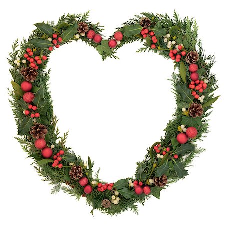 simsearch:400-06418836,k - Christmas heart wreath with red bauble decorations, holly, mistletoe, ivy, pinecones and cedar leaf sprigs over white background. Stock Photo - Budget Royalty-Free & Subscription, Code: 400-07086948