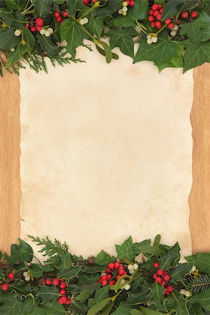 Christmas border with holly, ivy and mistletoe on old parchment paper over oak background. Stock Photo - Budget Royalty-Free & Subscription, Code: 400-07086959