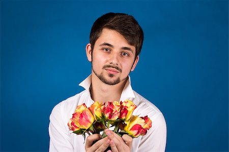 pavelshlykov (artist) - Man with bouquet of red roses. On blue background. Stock Photo - Budget Royalty-Free & Subscription, Code: 400-07087869