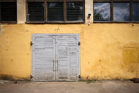 simsearch:400-04990381,k - Old wooden gate in grungy yellow wall Stock Photo - Budget Royalty-Free & Subscription, Code: 400-07088574