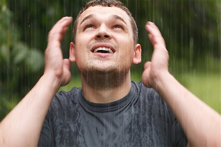 rain shelter - Young unshaven man getting wet under the rain. Stock Photo - Budget Royalty-Free & Subscription, Code: 400-07089327