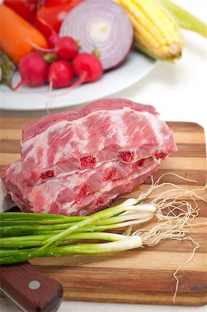 chopping fresh pork ribs with vegetables and herbs ready to cook Stock Photo - Budget Royalty-Free & Subscription, Code: 400-07089597