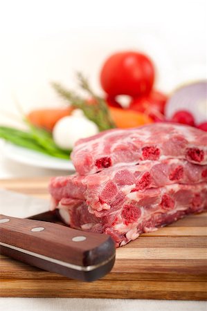 chopping fresh pork ribs with vegetables and herbs ready to cook Stock Photo - Budget Royalty-Free & Subscription, Code: 400-07095348