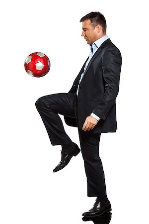 one caucasian business man playing juggling soccer ball in studio isolated on white background Stock Photo - Budget Royalty-Free & Subscription, Code: 400-07095563
