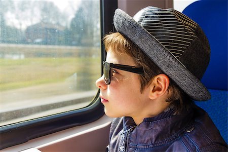 Handsome boy in sunglasses rides on a train Stock Photo - Budget Royalty-Free & Subscription, Code: 400-07096101