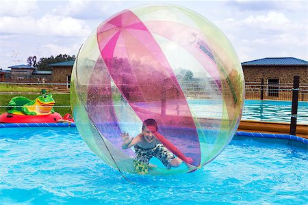 Boy in a ball on the water. Water Zorbing Stock Photo - Budget Royalty-Free & Subscription, Code: 400-07096649