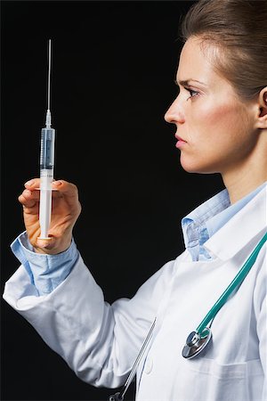 Doctor woman with syringe on black background Stock Photo - Budget Royalty-Free & Subscription, Code: 400-07099886