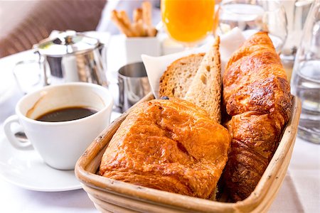 simsearch:400-05704519,k - Breakfast with coffee and croissants in a basket on table Stock Photo - Budget Royalty-Free & Subscription, Code: 400-07090186