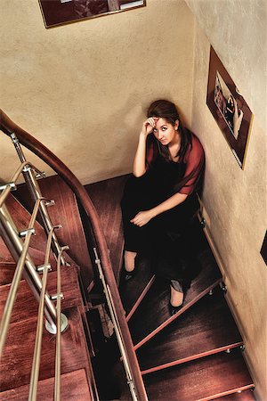 young beautiful lady sitting on stairway in luxury interior Stock Photo - Budget Royalty-Free & Subscription, Code: 400-07091102