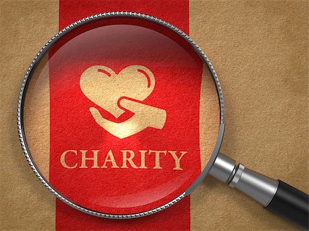Charity Concept: Magnifying Glass with Icon of Heart in the Hand and Word Charity on Old Paper with Red Vertical Line Background. Photographie de stock - Aubaine LD & Abonnement, Code: 400-07106009